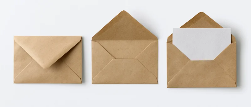 Three kraft paper envelopes arranged in a row, one closed, one open, one with a white card inside, on a white background