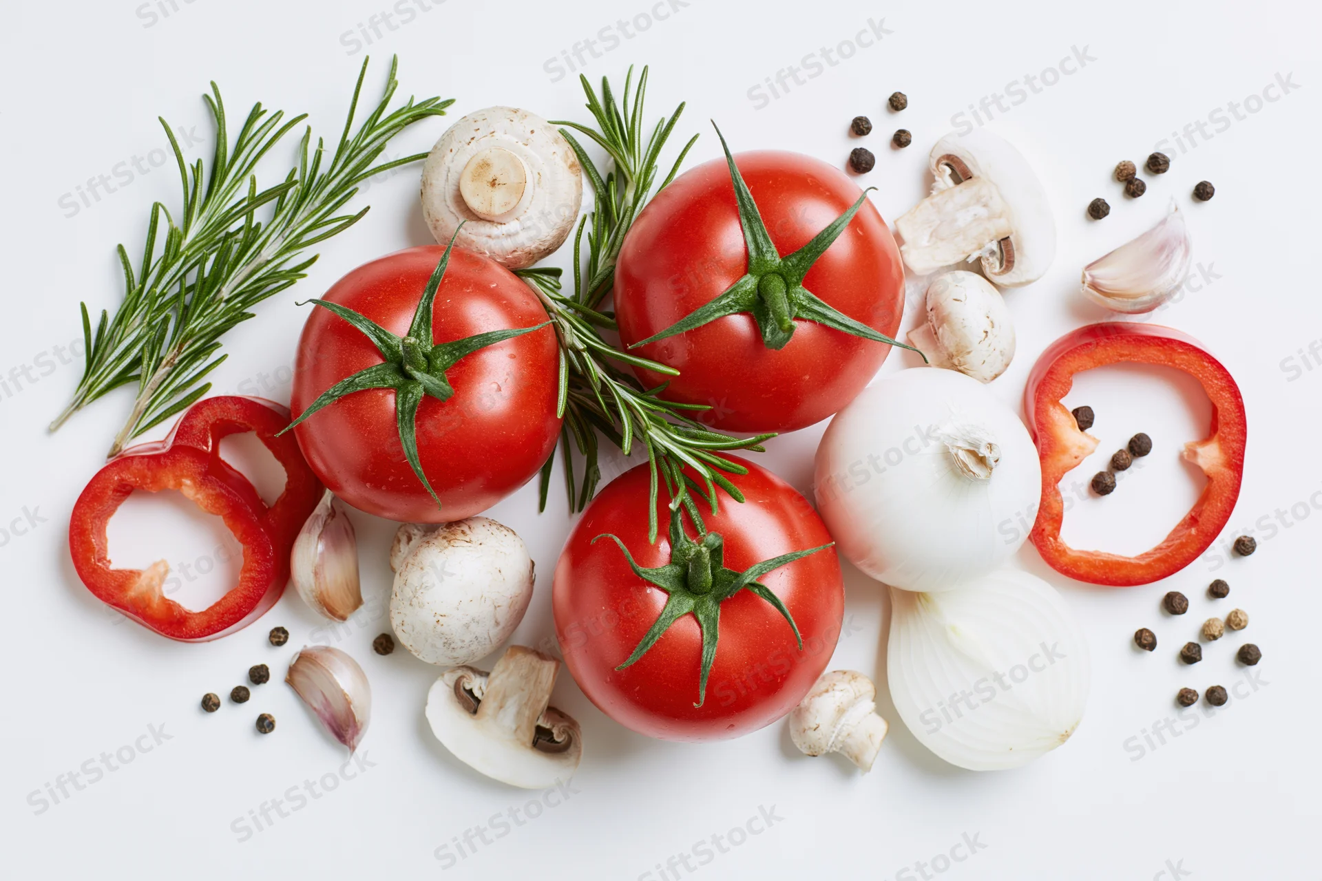 Ripe tomatoes with fresh herbs, vegetables and spices arranged on white surface