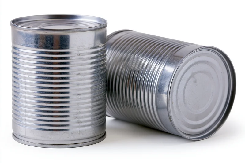 Two plain unlabeled steel tin cans arranged together on a white background