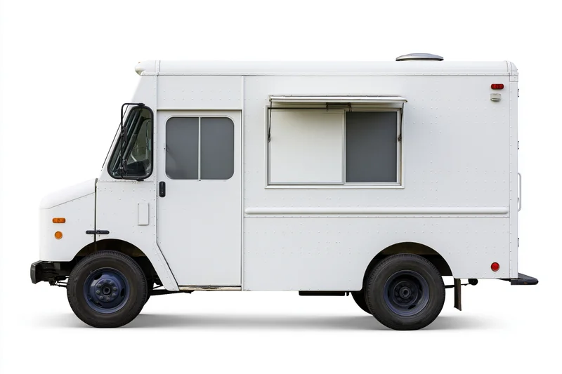 White food truck parked and viewed from the side with blank menu space