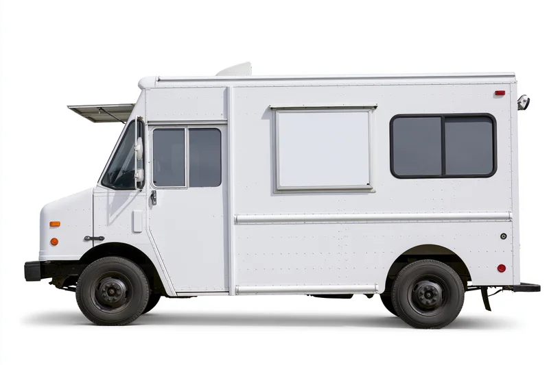 White food truck parked and viewed from the side with blank menu panel