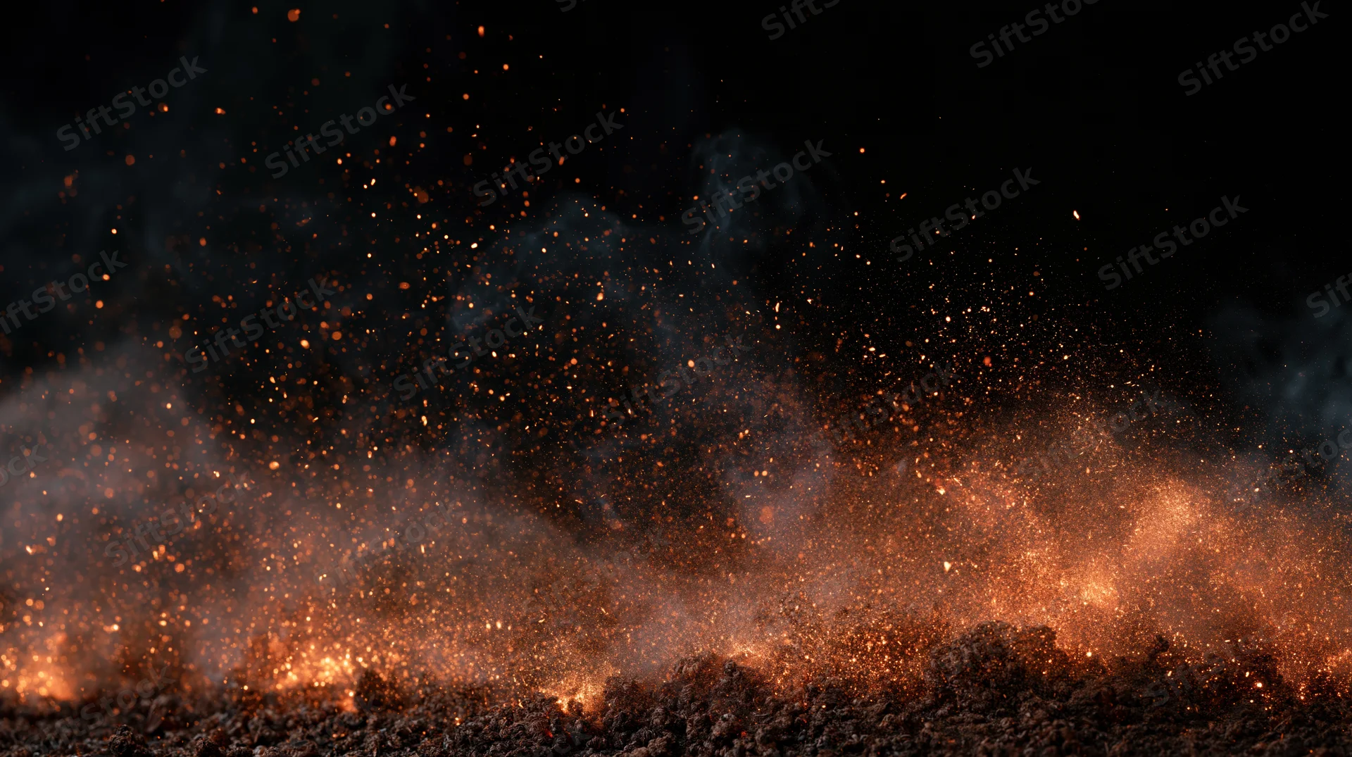 Fire embers and smoke drifting horizontally across dark ground at night