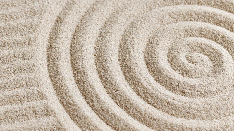 Raked sand forming a spiral pattern in a zen garden