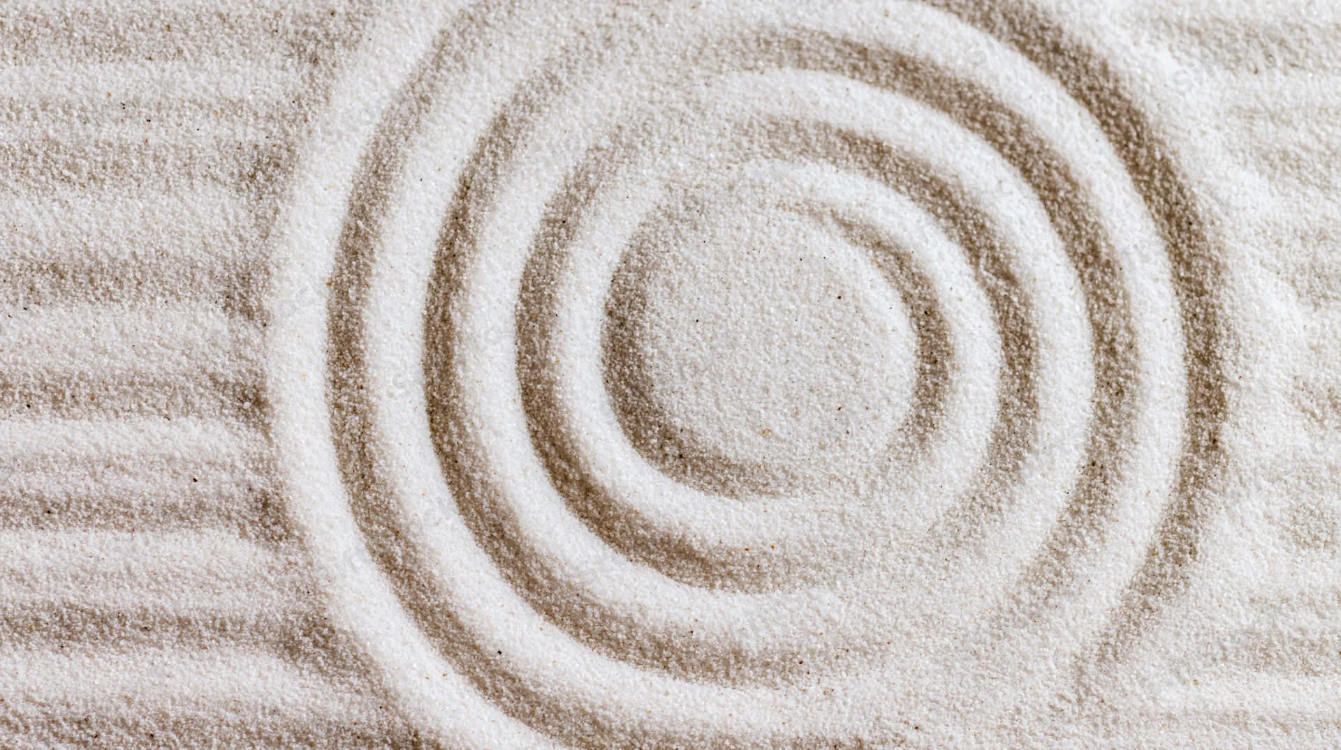 Raked sand forming concentric circles in a zen garden