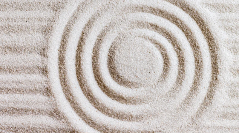 Raked sand forming concentric circles in a zen garden