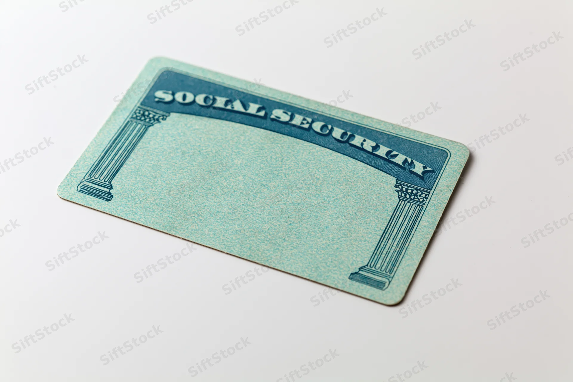 Blank us social security card lying flat on white surface