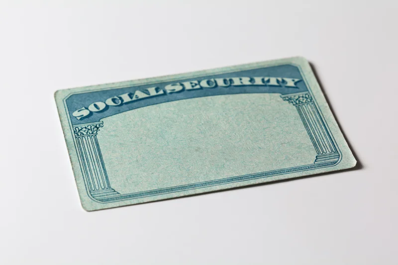 Blank us social security card lying flat on white surface
