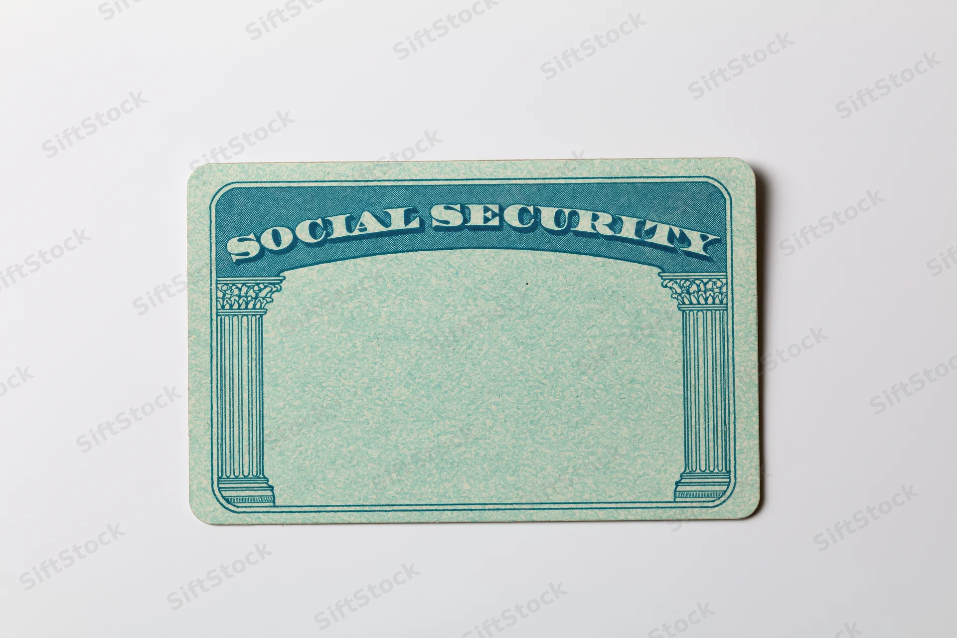 Blank us social security card lying flat on white surface