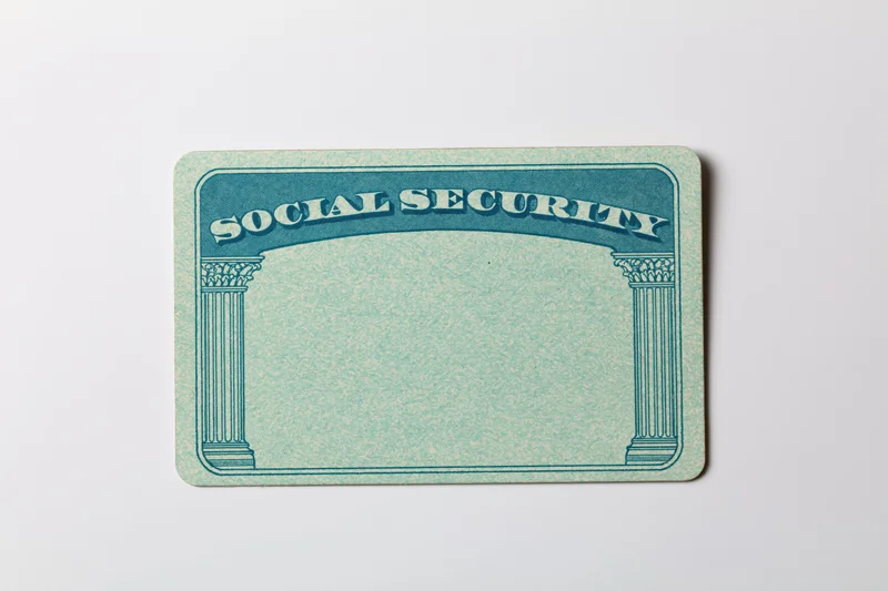 Blank us social security card lying flat on white surface