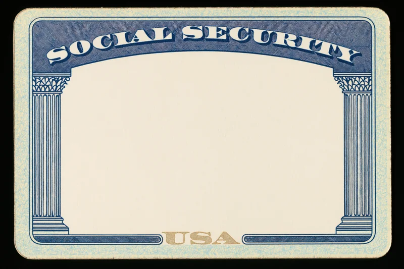 Blank united states social security card lying flat with blue border and columns, no personal information visible
