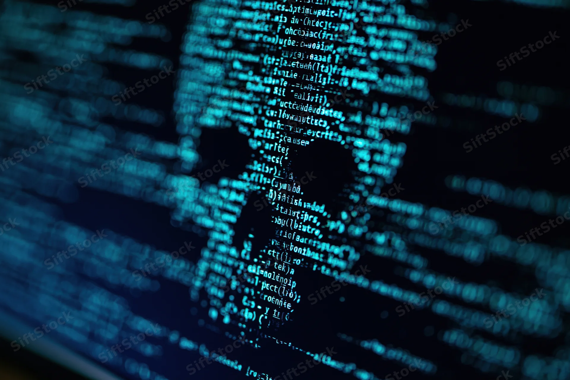 Glowing blue code displayed on a dark computer monitor screen
