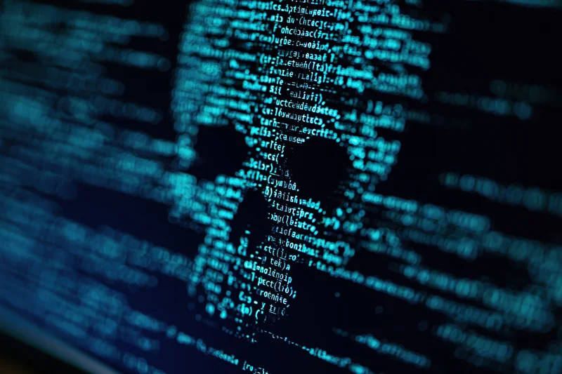 Glowing blue code displayed on a dark computer monitor screen