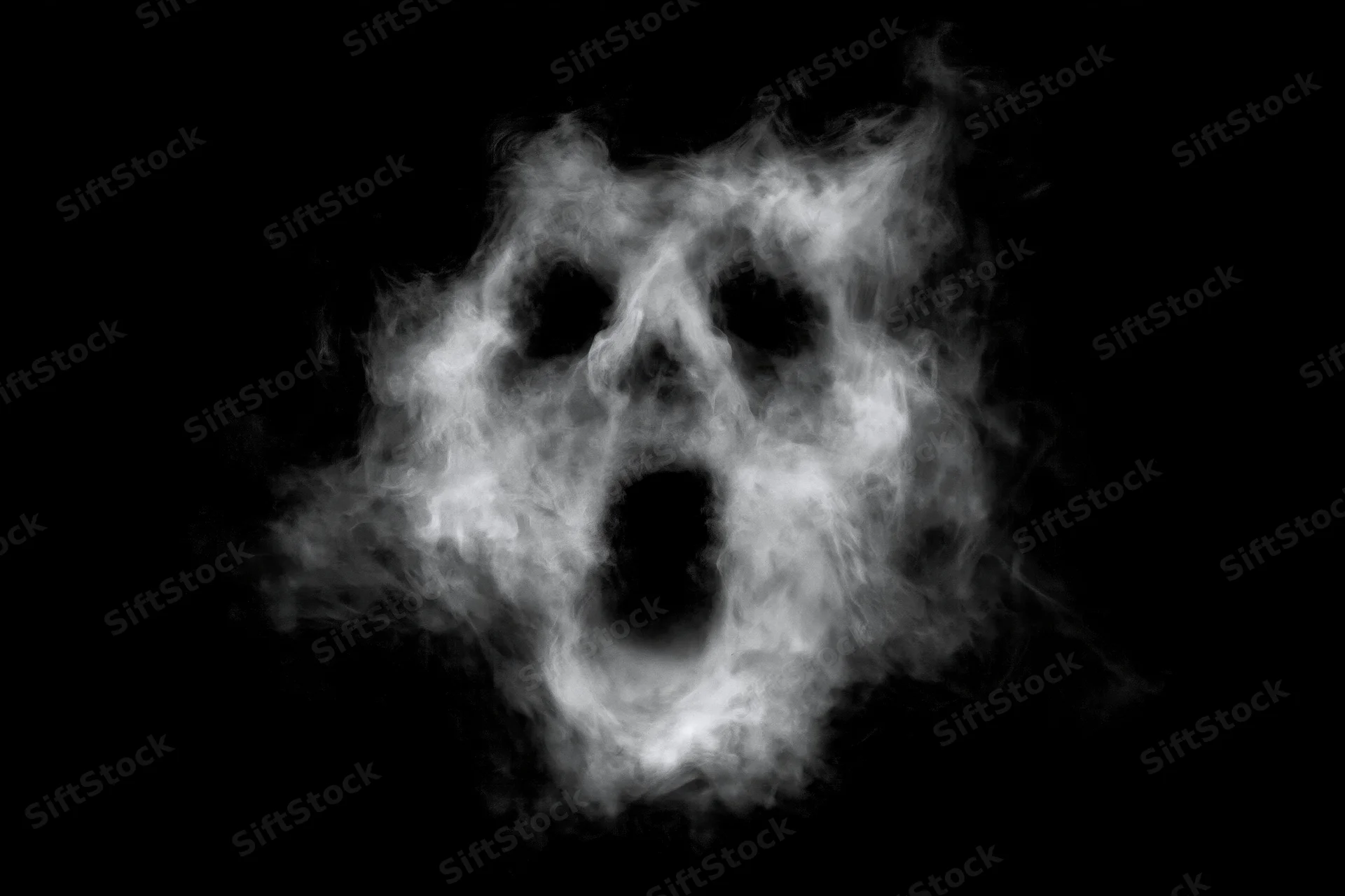 Ghostly face formed from swirling smoke against black background
