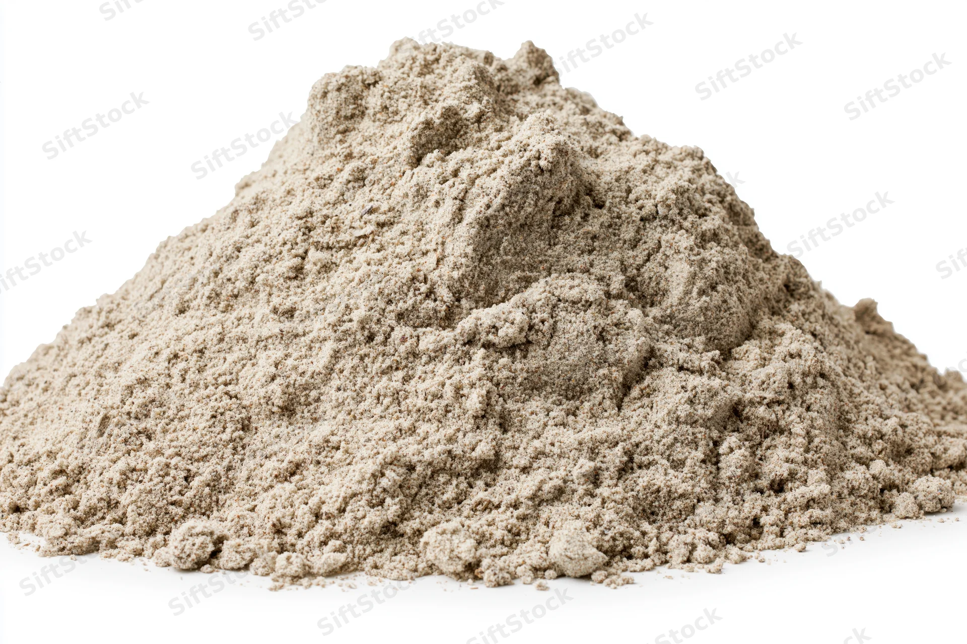 Mound of dry construction sand piled on a flat white surface