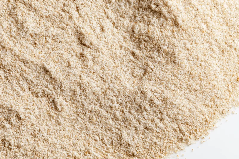 Closeup of fine dry sand scattered on white background