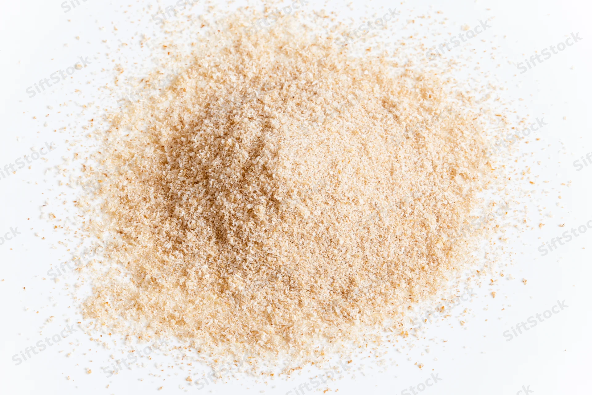 A pile of fine beige spice powder scattered on a white surface