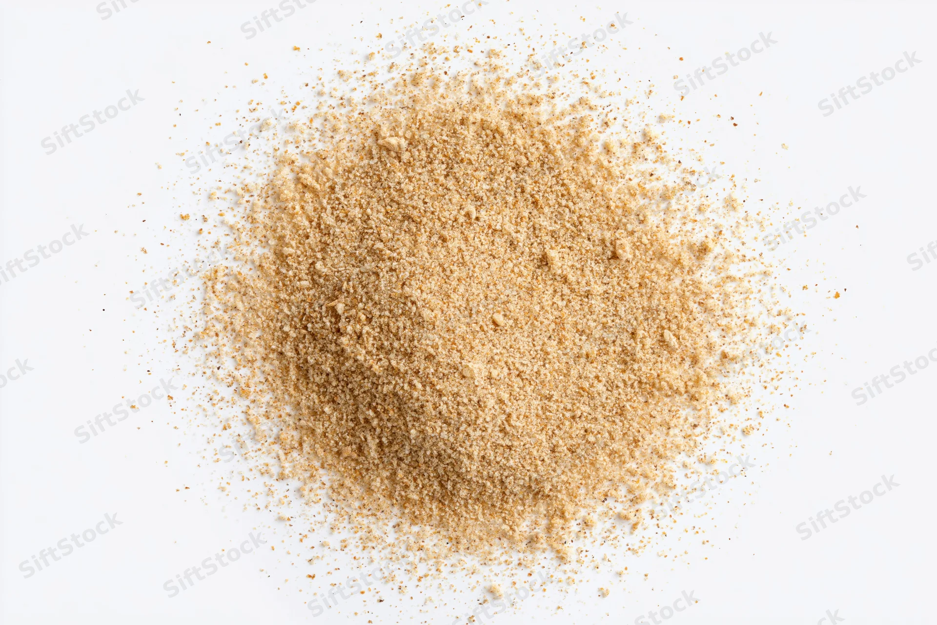 A pile of fine beige spice powder on a white surface