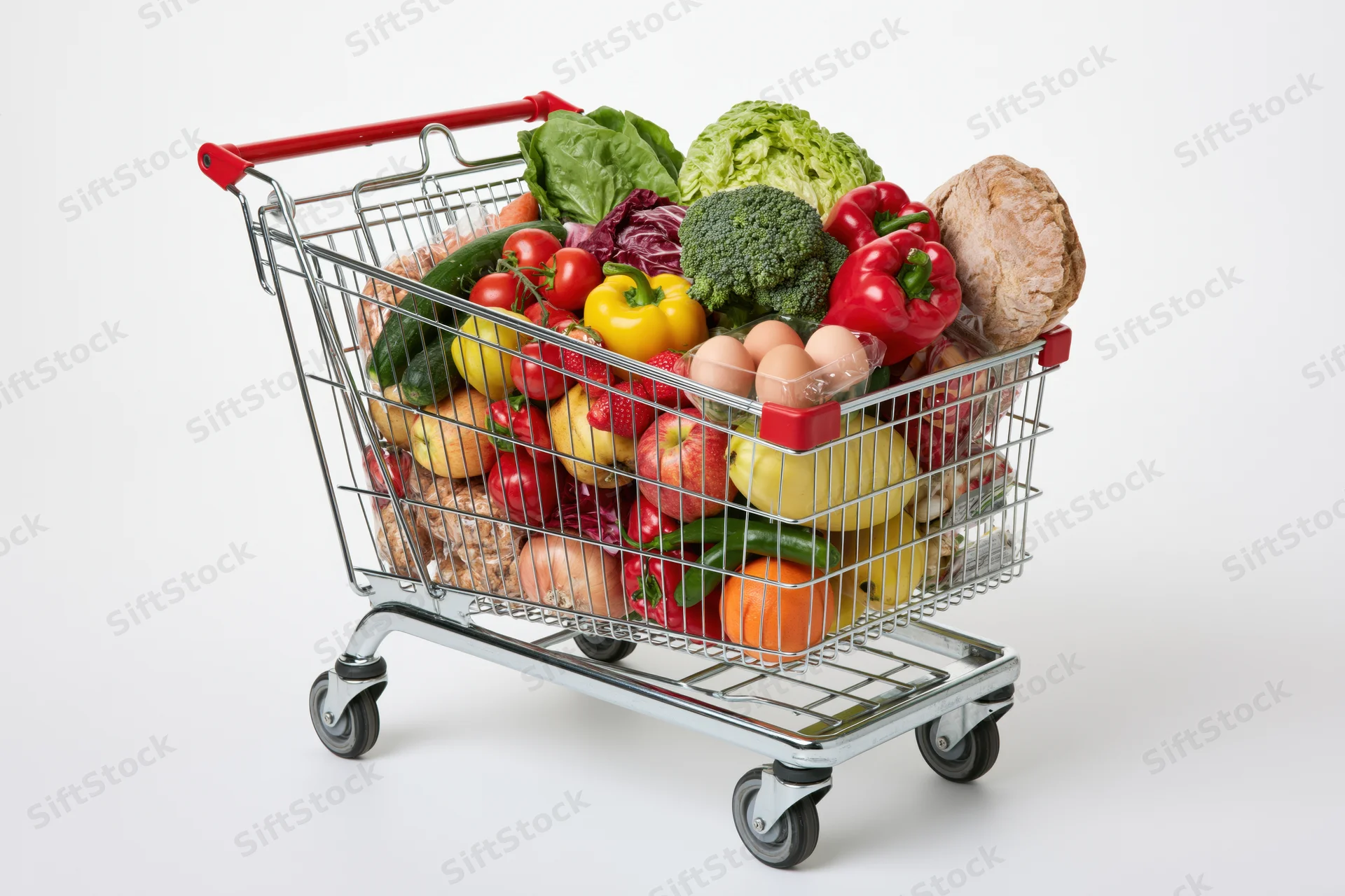Metal shopping cart filled with fresh fruits and vegetables on white background