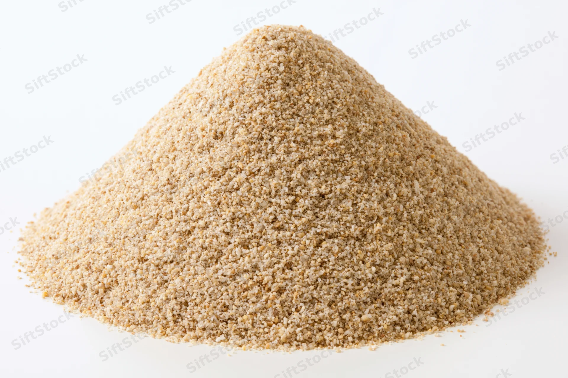 Conical pile of coarse dry sand on white background