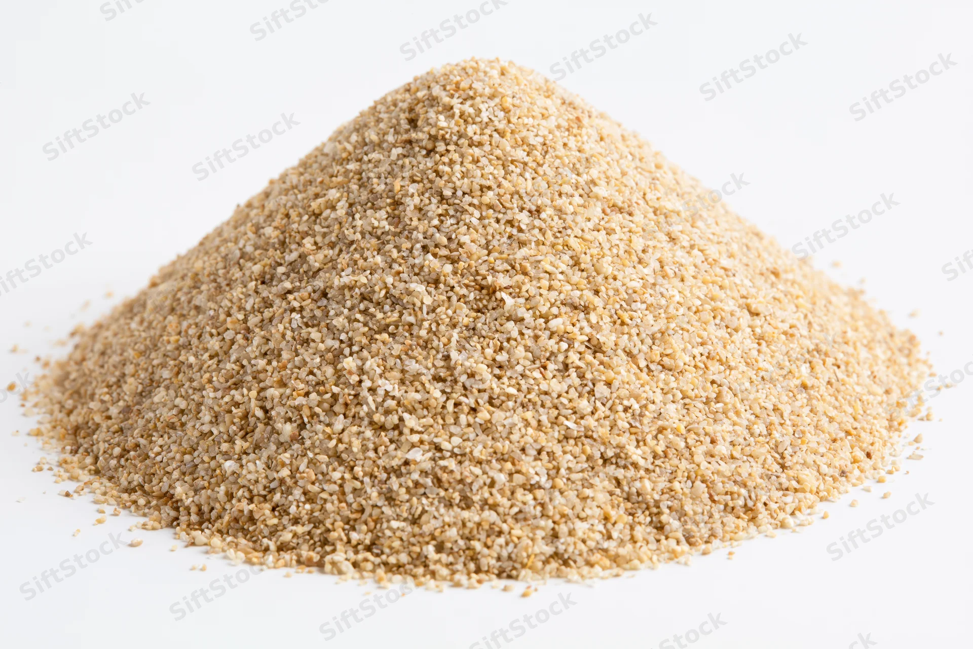 Conical pile of coarse dry sand on white background