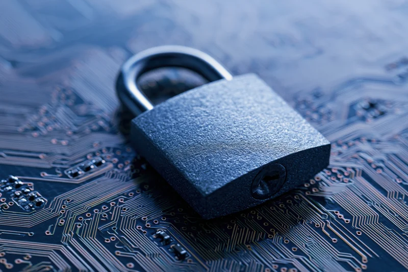 Metal padlock resting on a printed circuit board