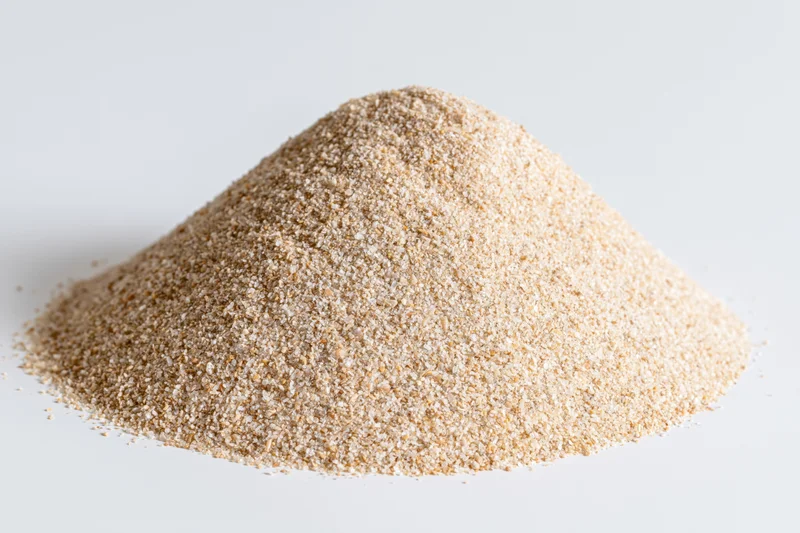 A pile of fine-grain sand on a white background