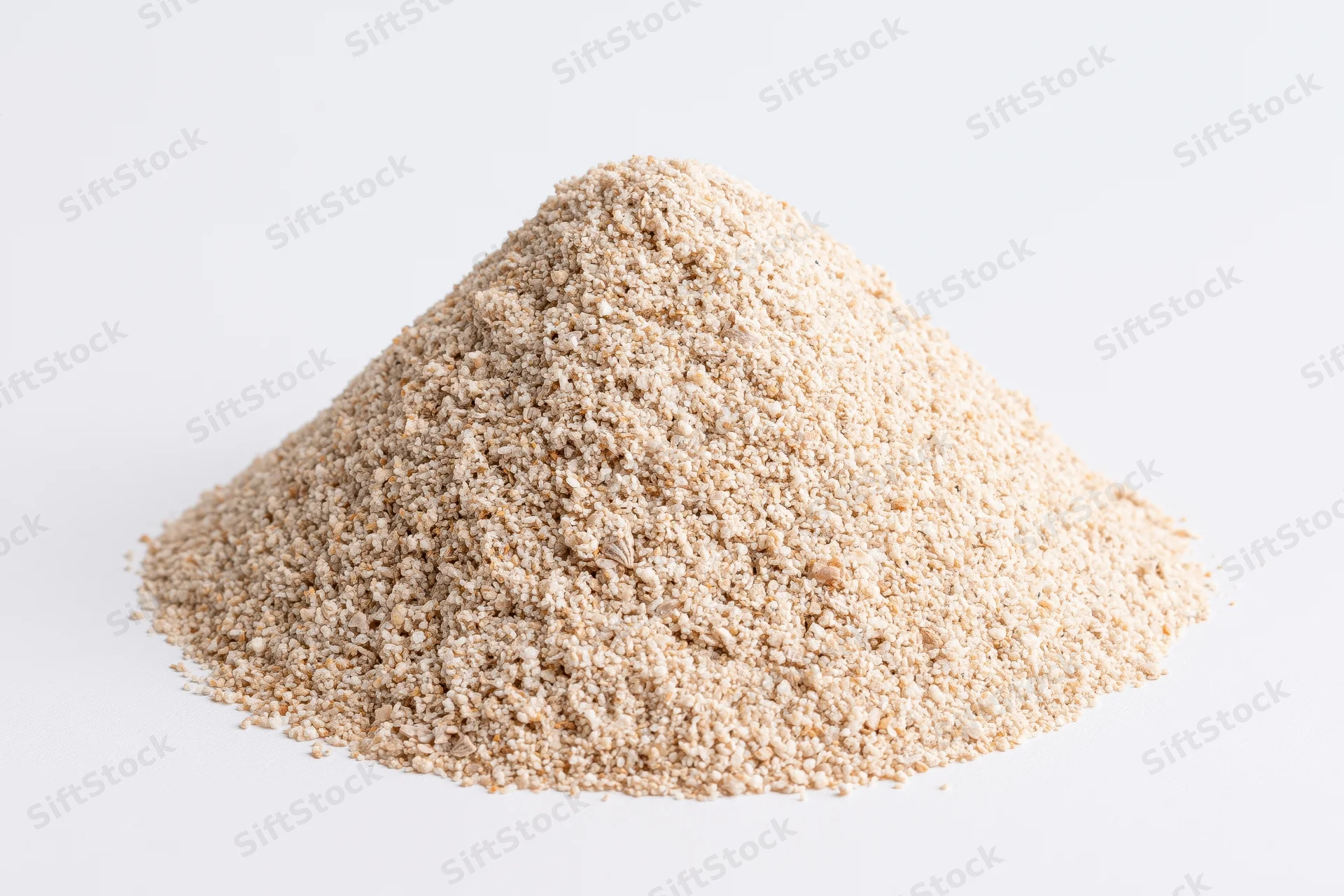 A pile of fine-grain sand on a white surface