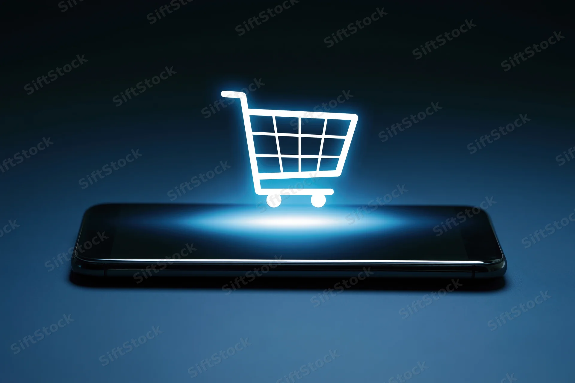 Glowing shopping cart icon hovering above a smartphone on a dark surface