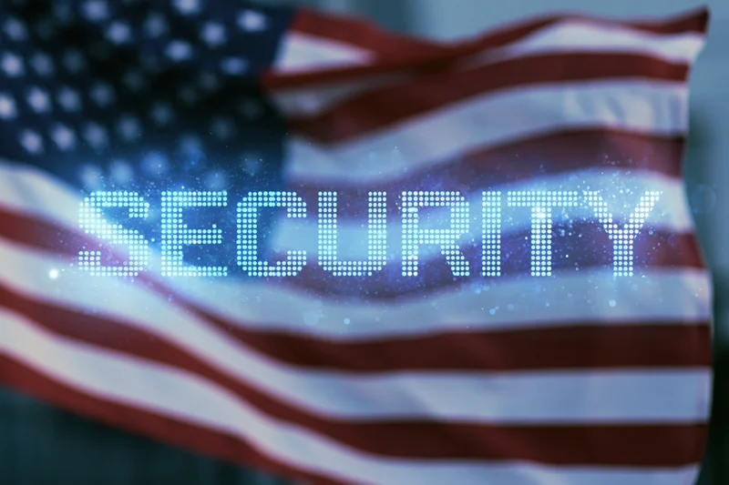 American flag waving with digital security text projection overlaid