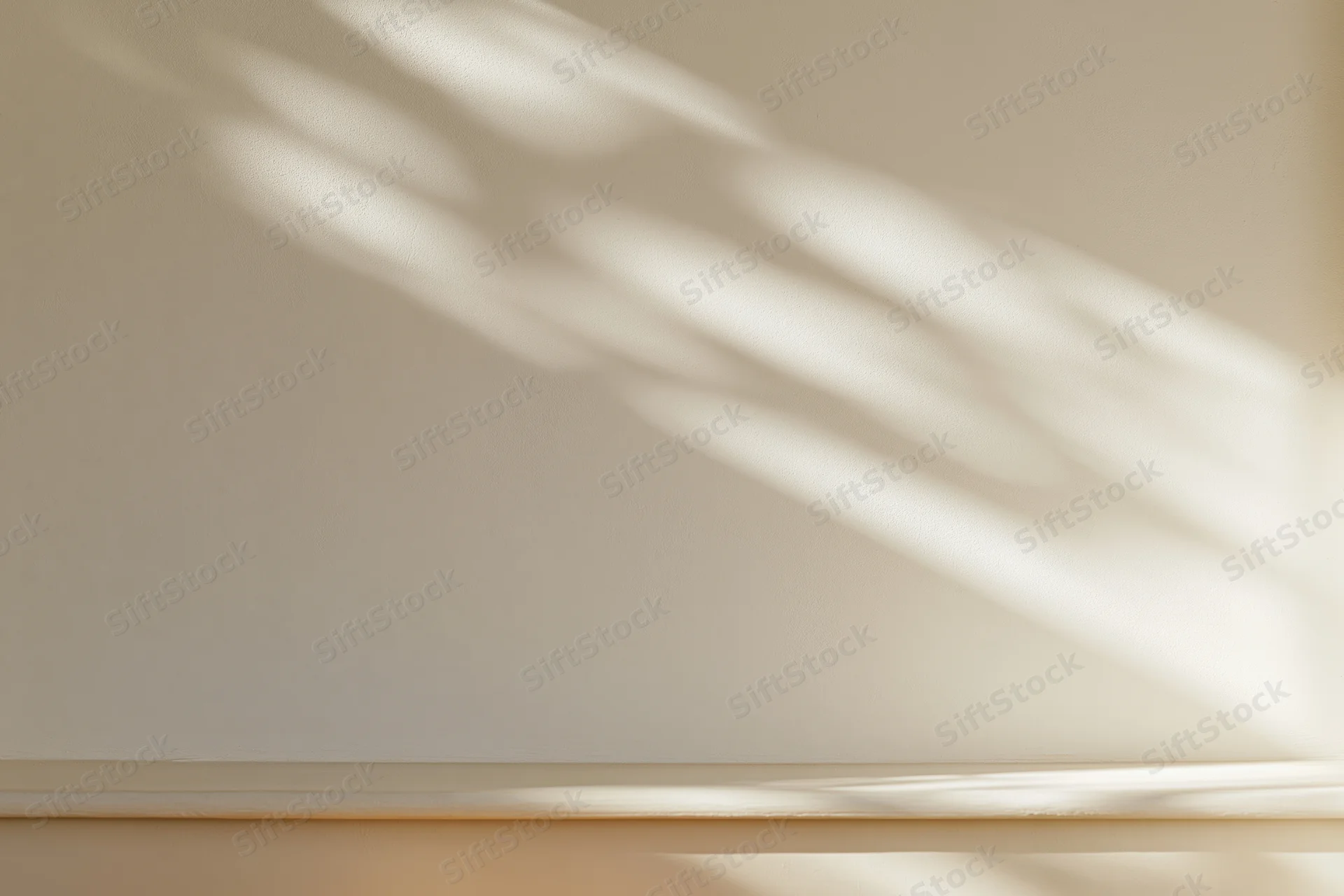Cream-white plaster wall with soft sunlight casting diagonal shadows across smooth matte surface in indoor room setting