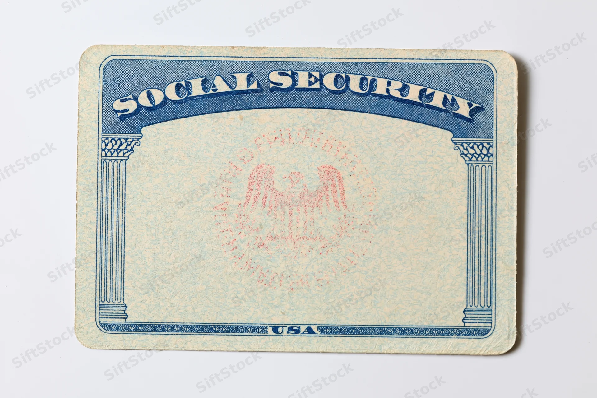 Blank us social security card lying flat on white surface