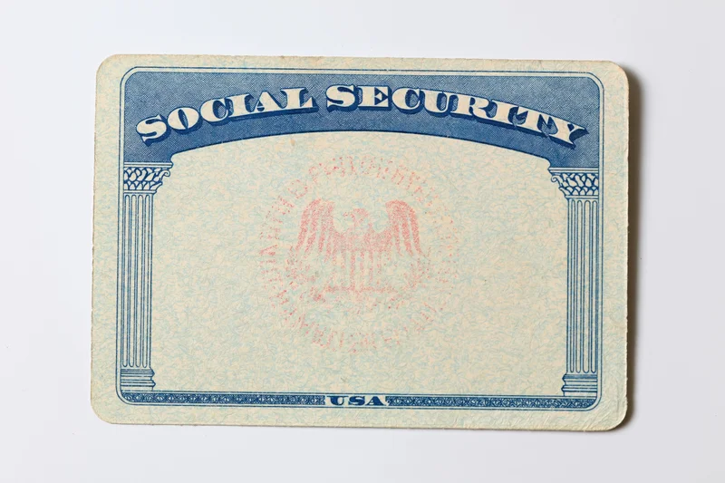 Blank us social security card lying flat on white surface