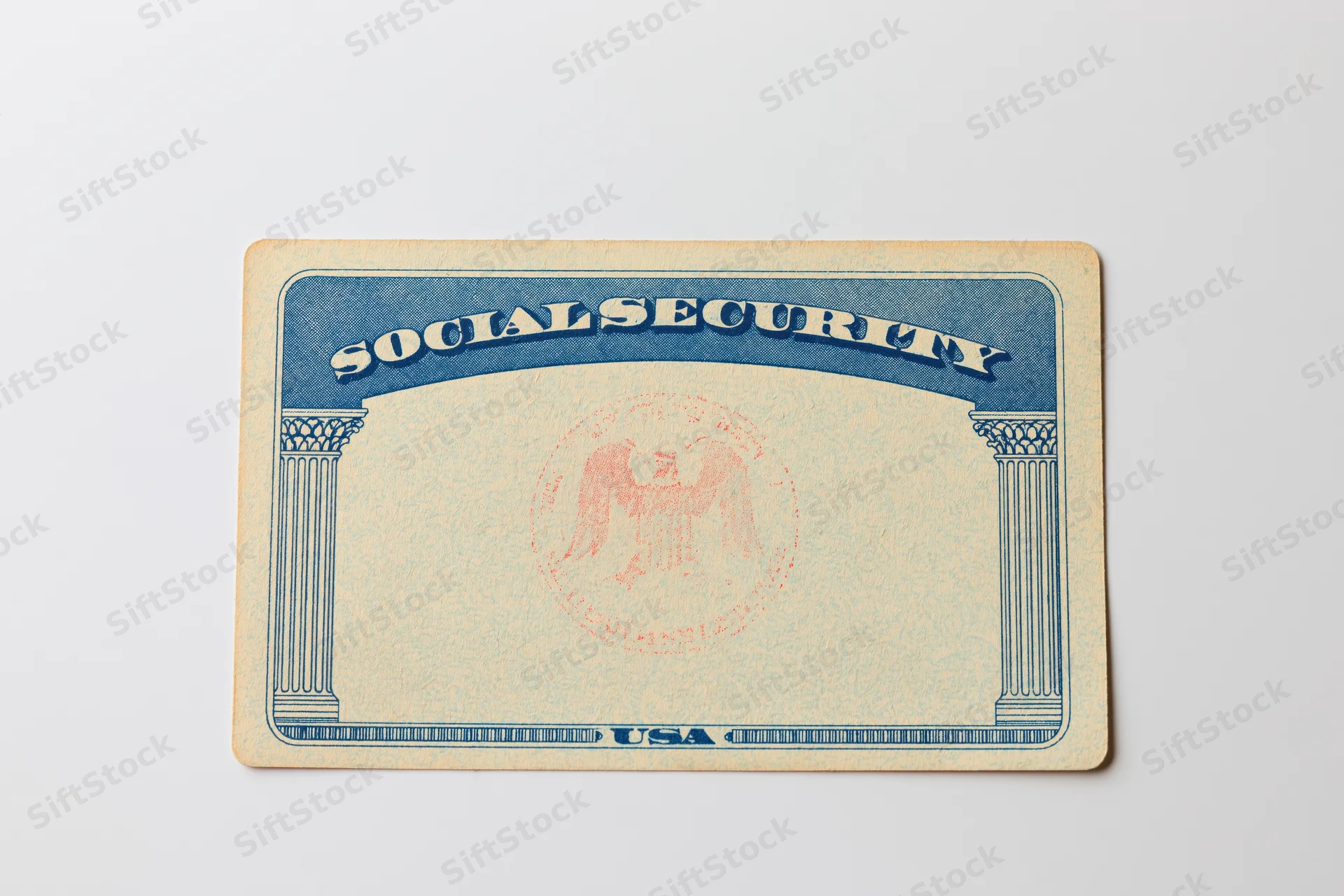Blank us social security card lying flat on white surface
