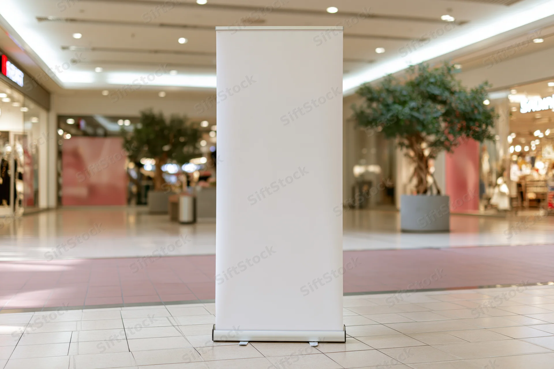 Blank white pull-up banner stand on polished tile floor in shopping mall interior