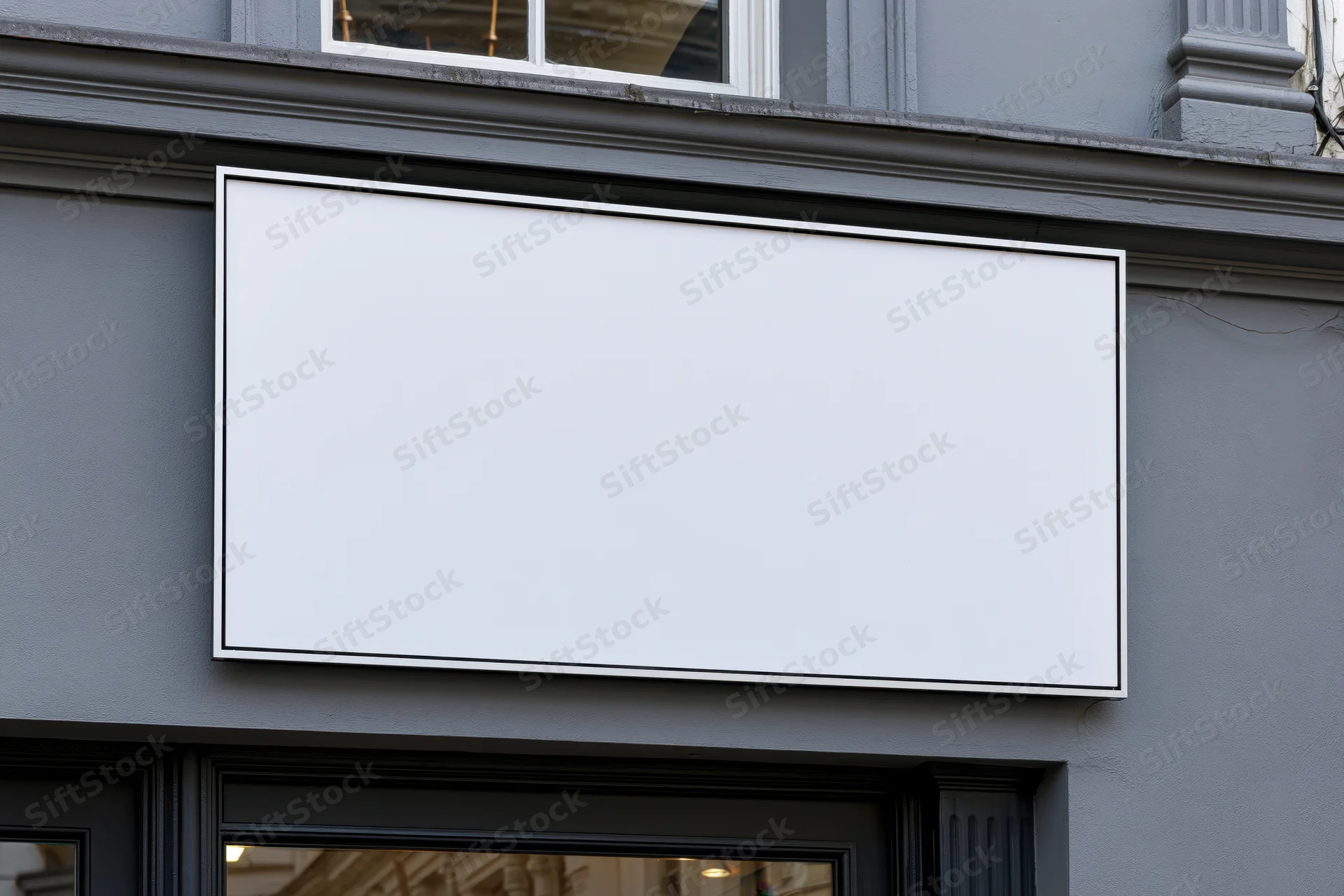 Blank white rectangular sign on a gray storefront facade