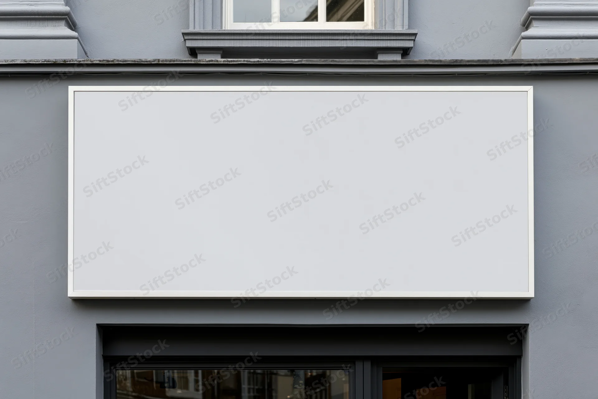 Blank white rectangular sign mounted on gray building facade above shop entrance
