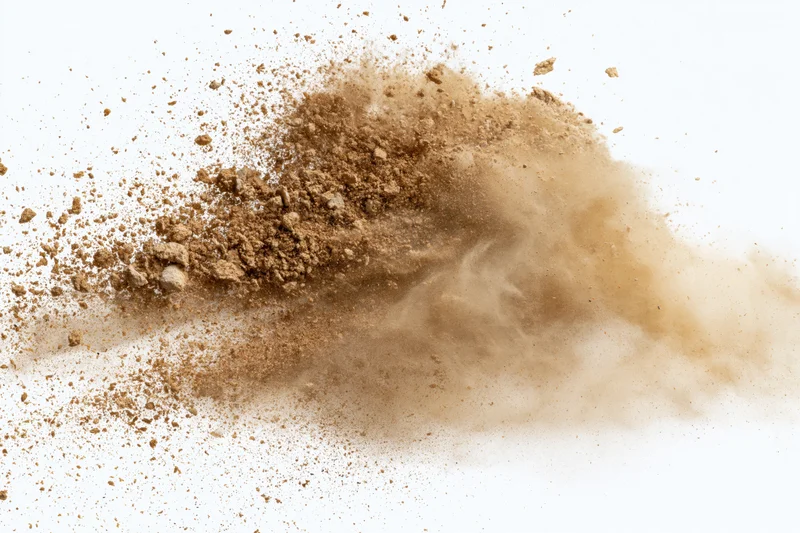 Brown sand and dirt powder exploding mid-air against white background