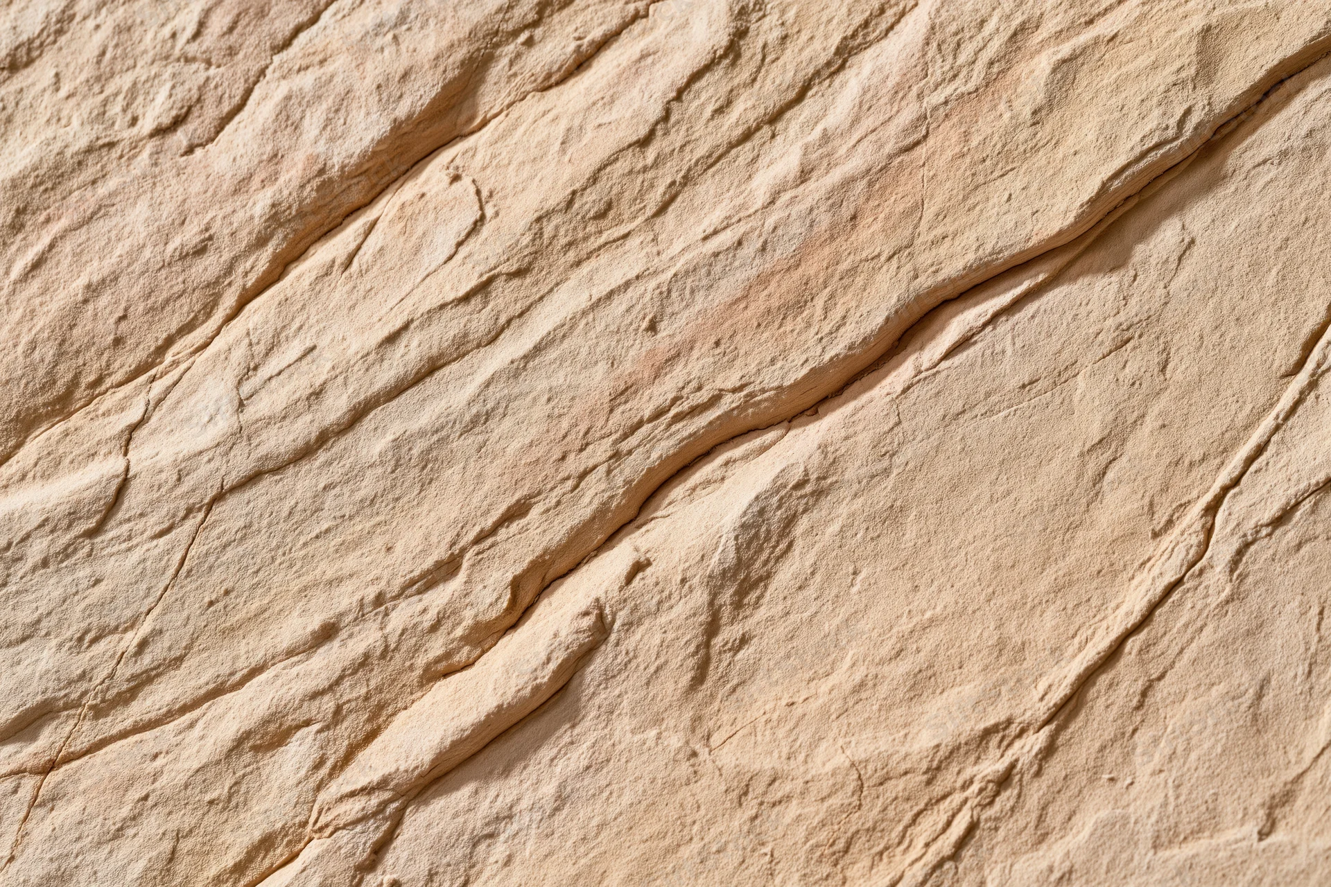 Close-up of rough sandstone surface with visible layers and cracks
