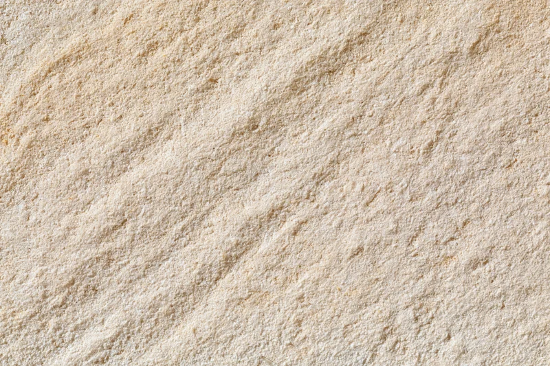 Close-up flat lay of rough sandstone surface filling the frame