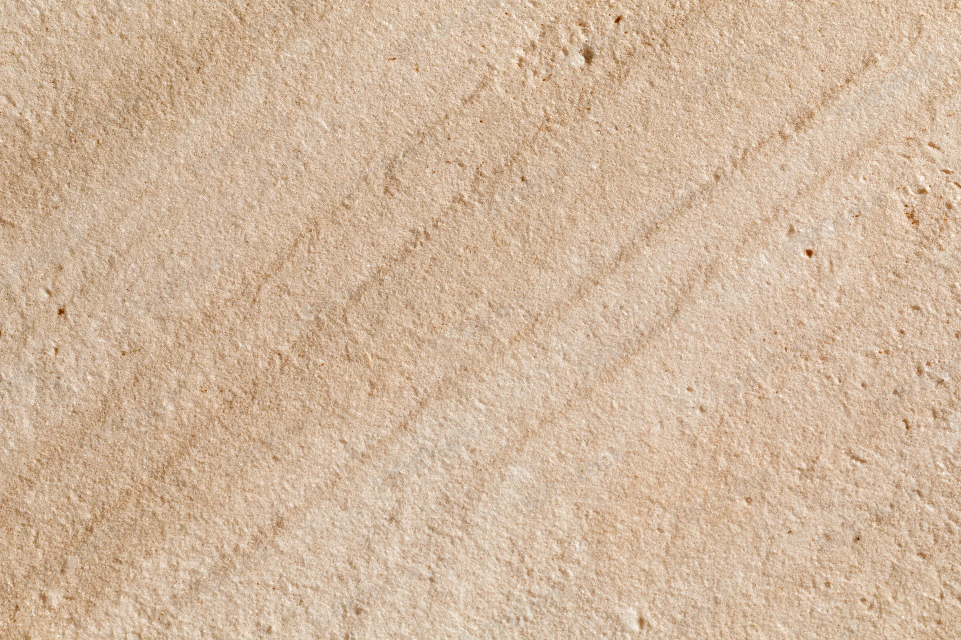 Close-up of rough sandstone surface with natural texture and grain patterns