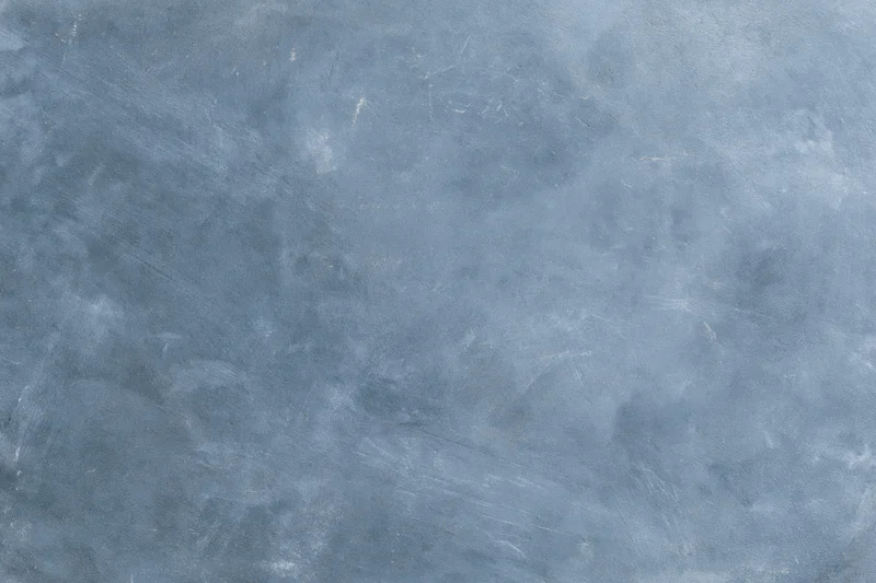 Weathered concrete surface with gray-blue texture and subtle cracks