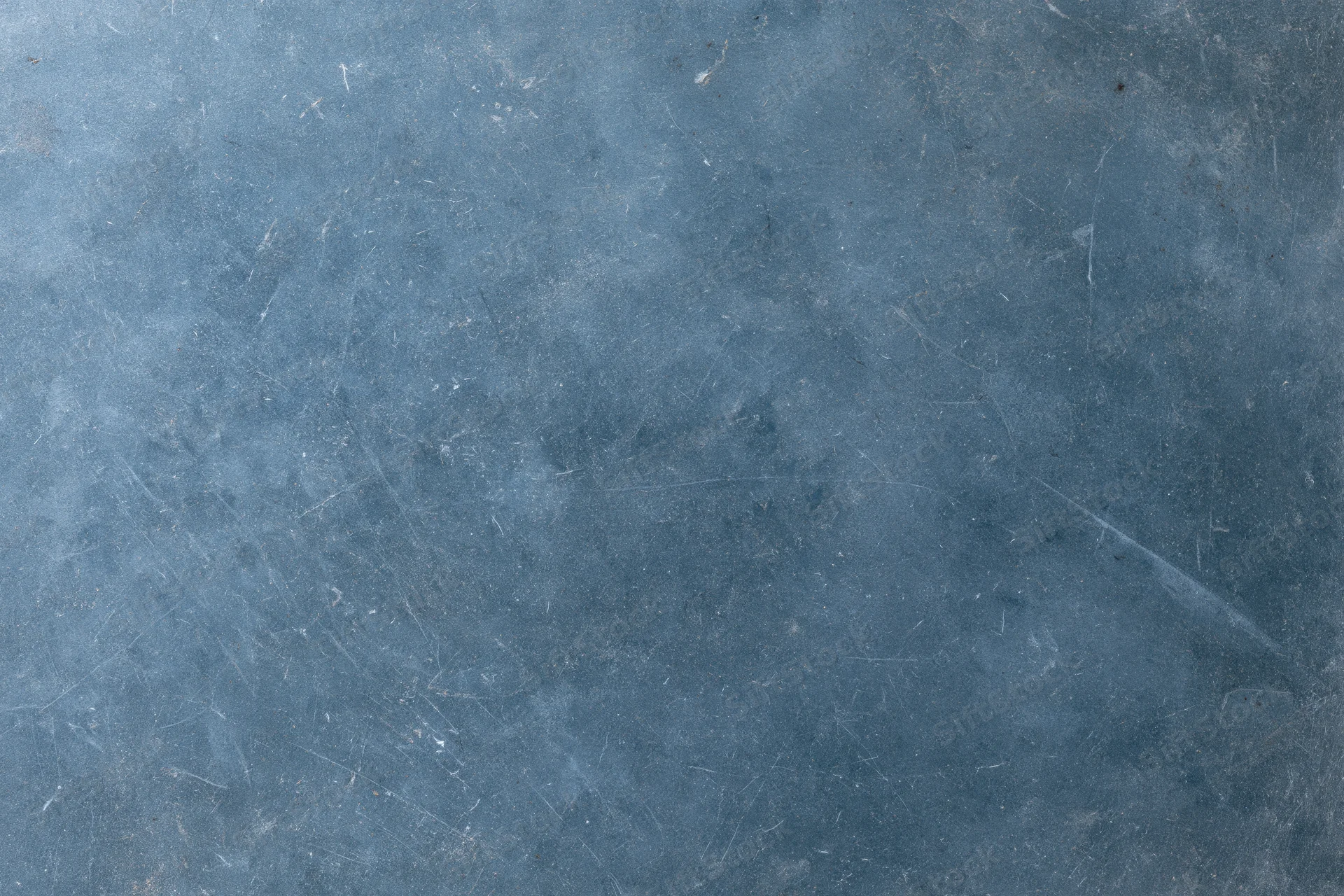Weathered concrete surface with scratches and discoloration showing aged texture