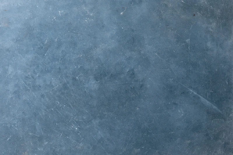 Weathered concrete surface with scratches and discoloration showing aged texture