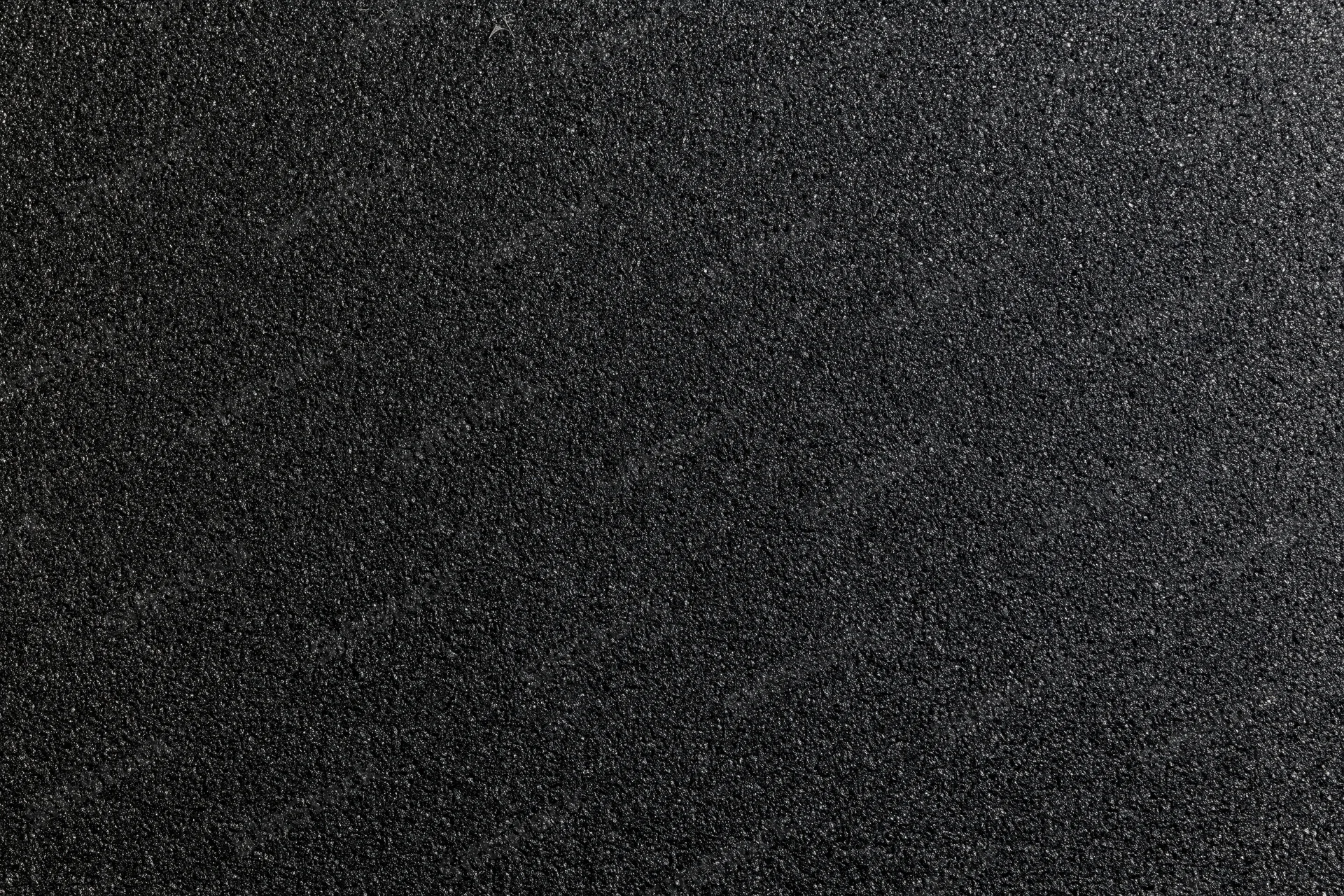 Close-up of black foam surface with fine granular texture