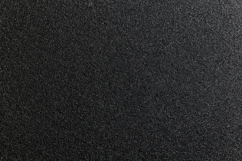 Close-up of black foam surface with fine granular texture