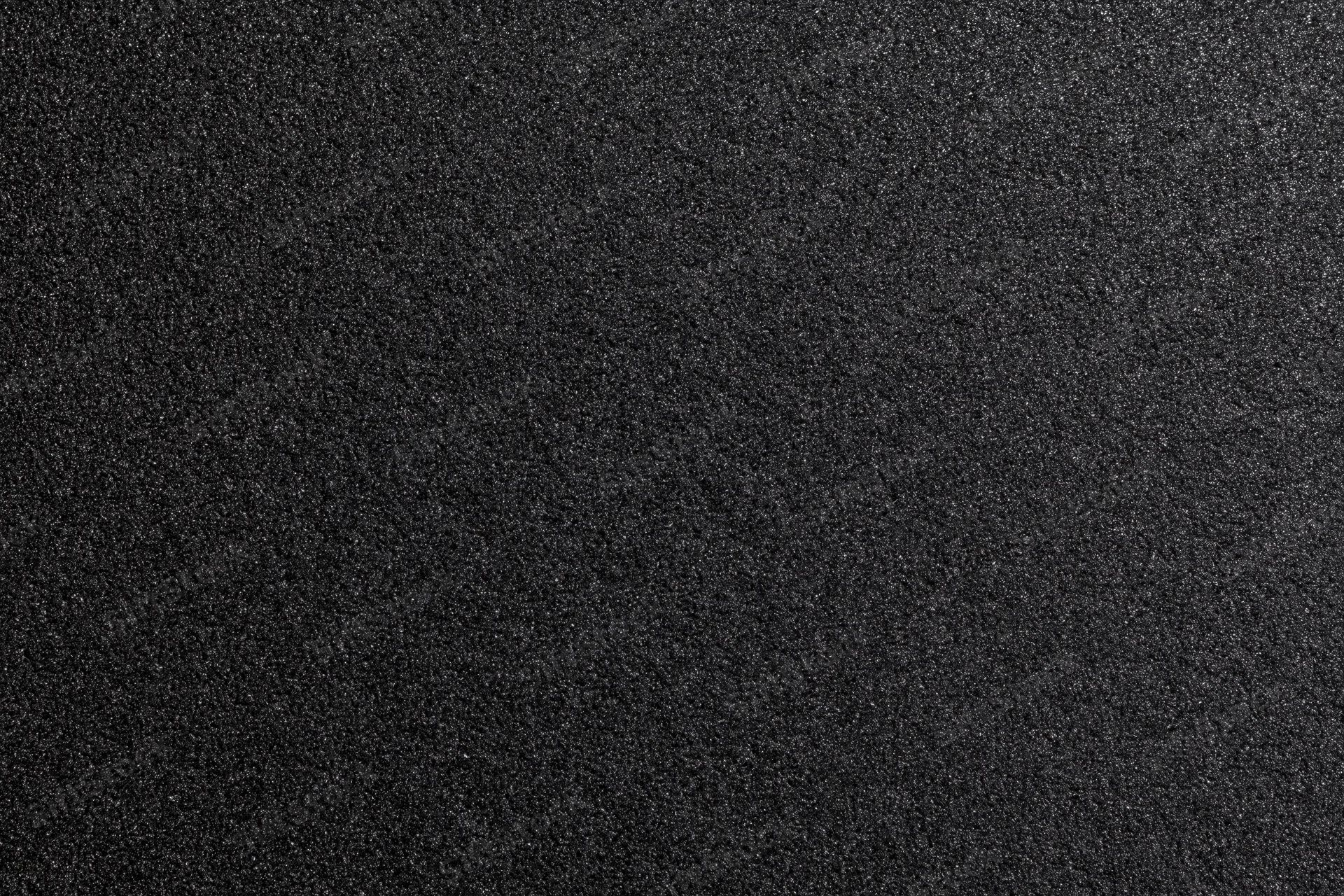 Close-up of black foam surface with fine granular texture