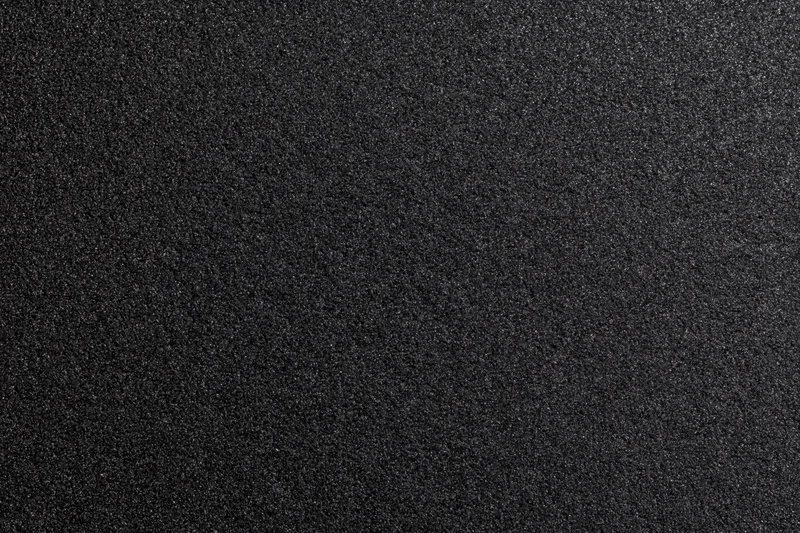 Close-up of black foam surface with fine granular texture
