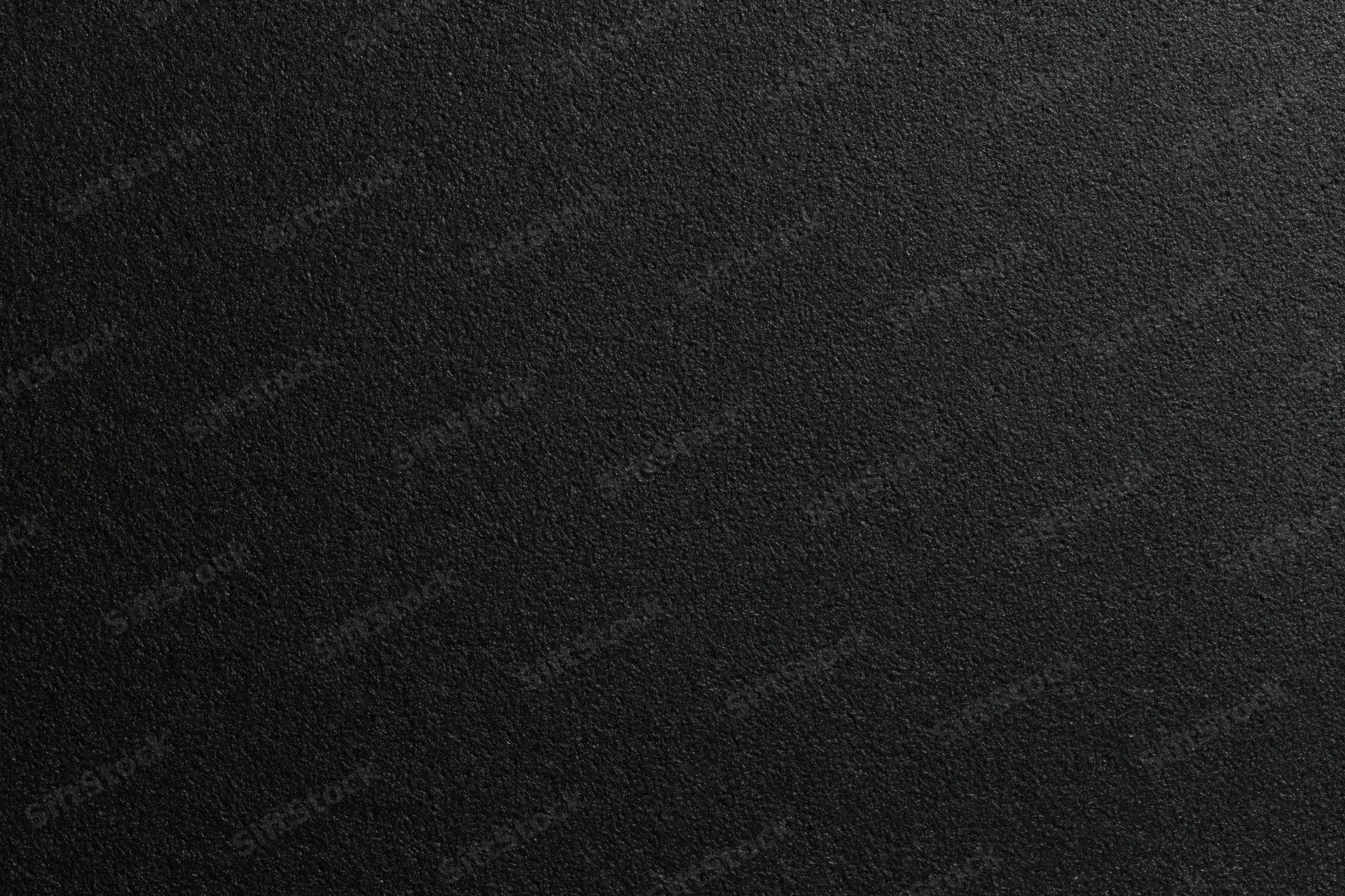 Close-up of black foam surface with fine matte texture for background use