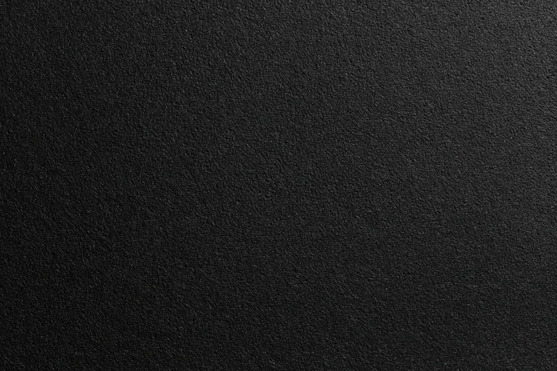 Close-up of black foam surface with fine matte texture for background use