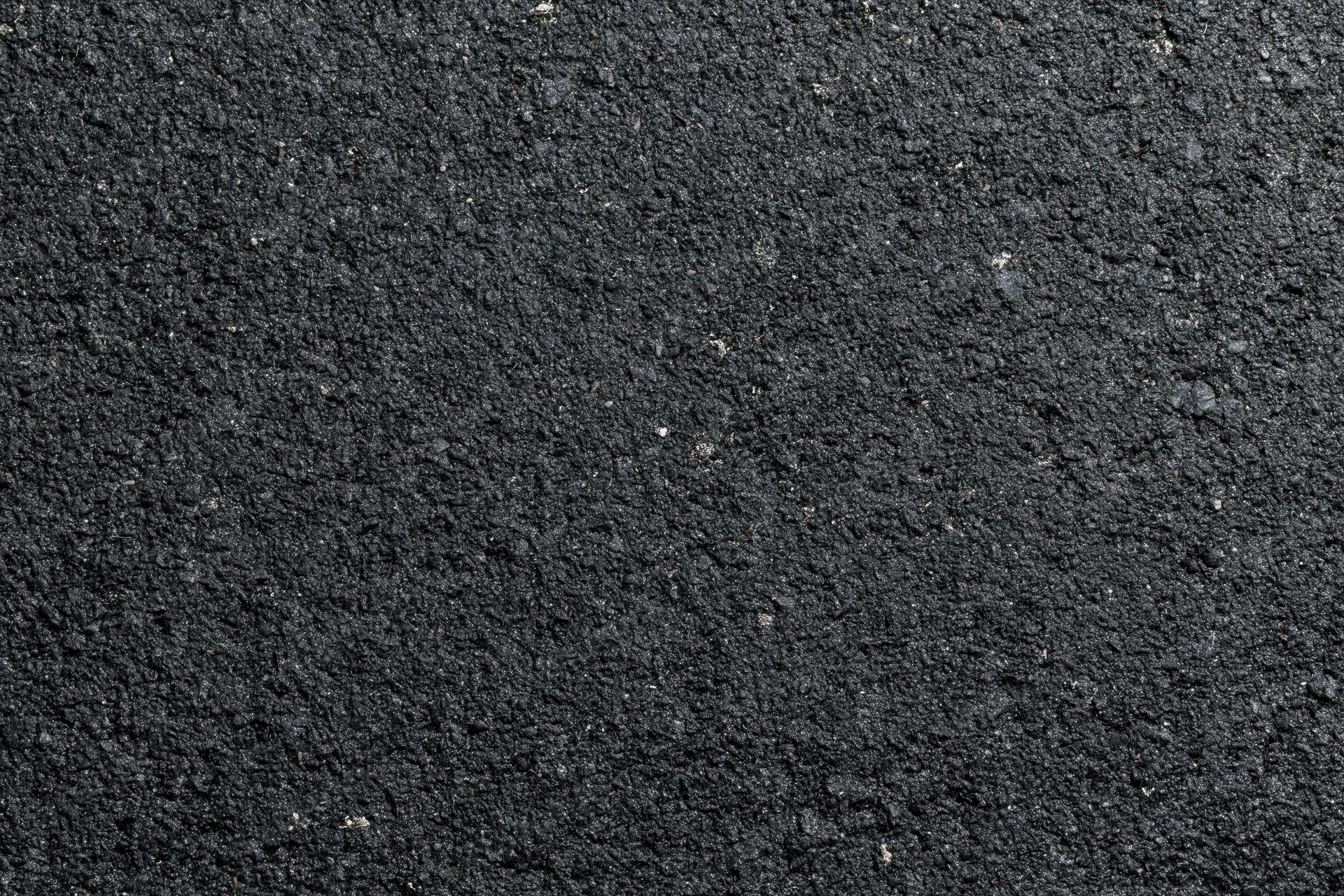 Close-up of dark asphalt surface texture filling the frame